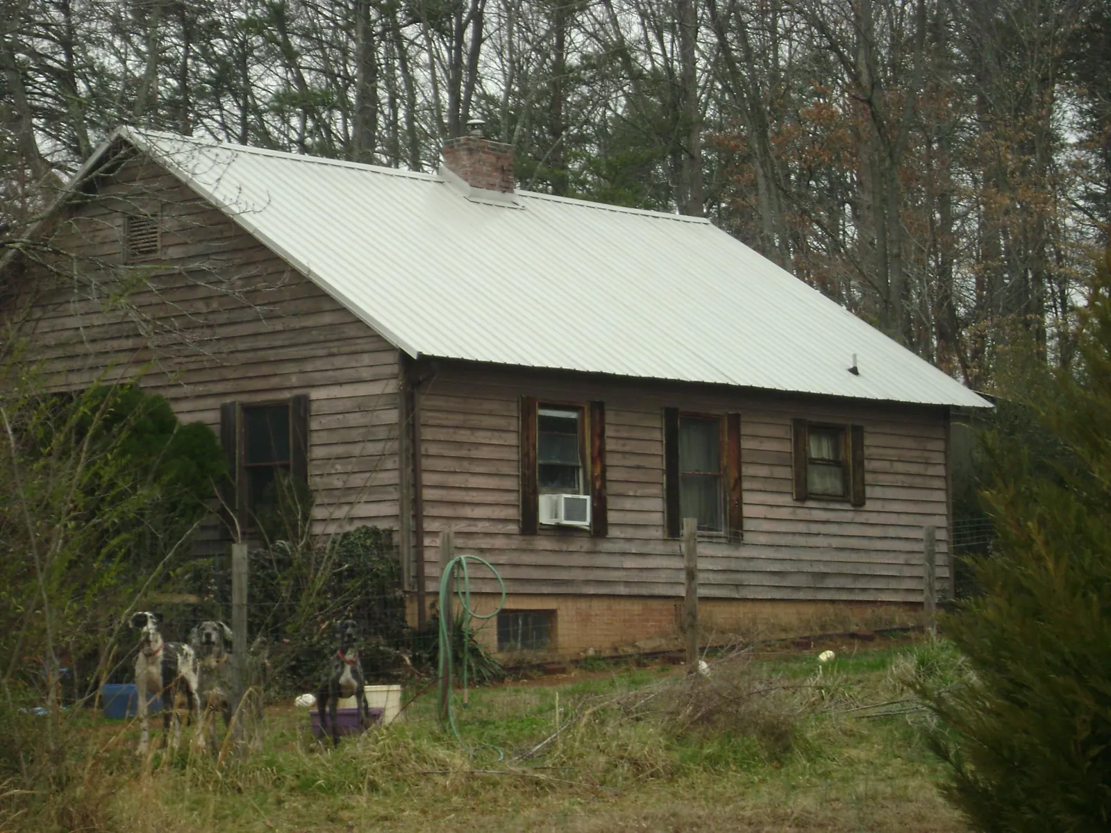White metal roof on an old wood sided farmhouse, from a Metal Roof Installation job in Eutaw